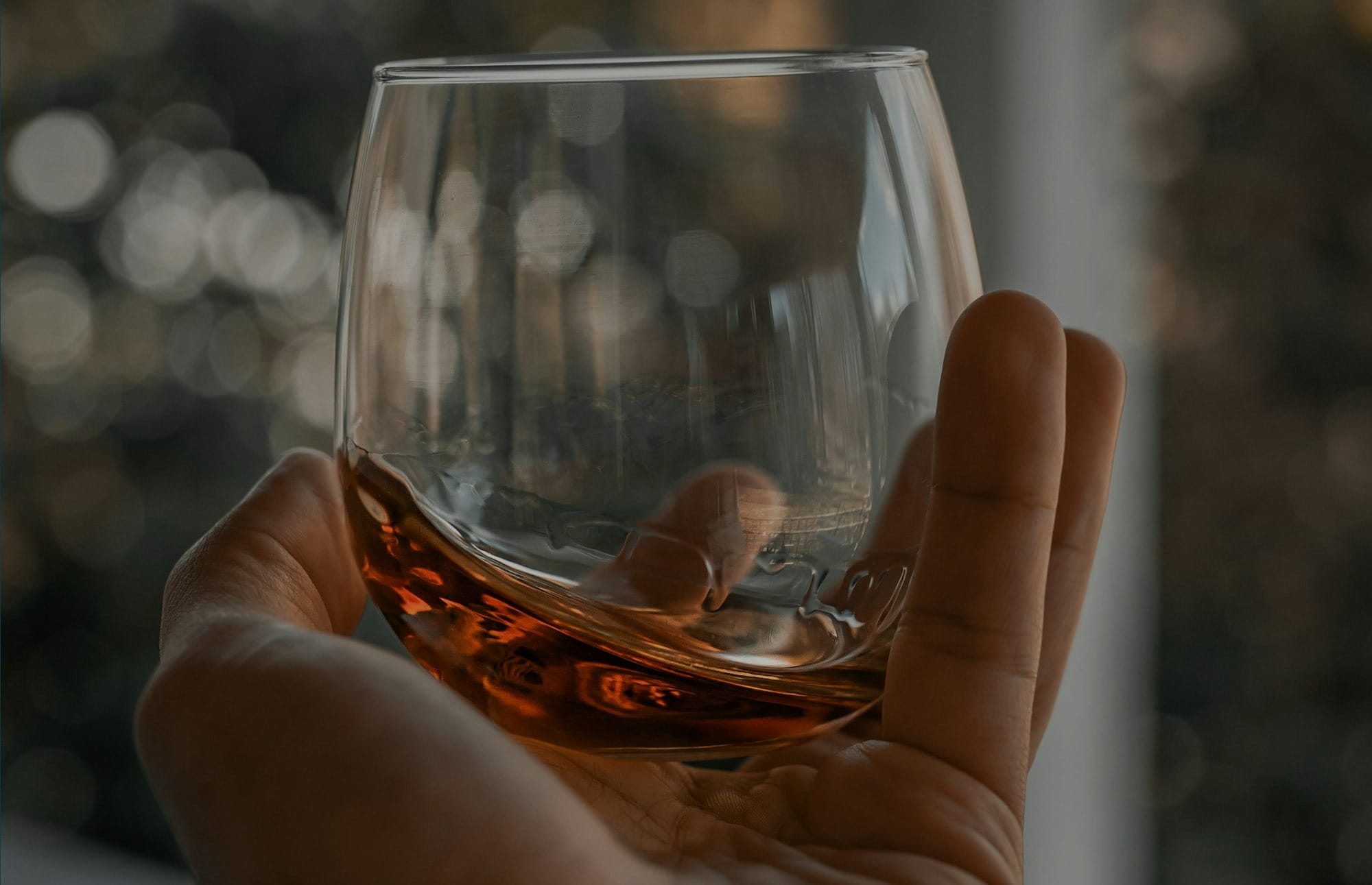 person holding clear drinking glass